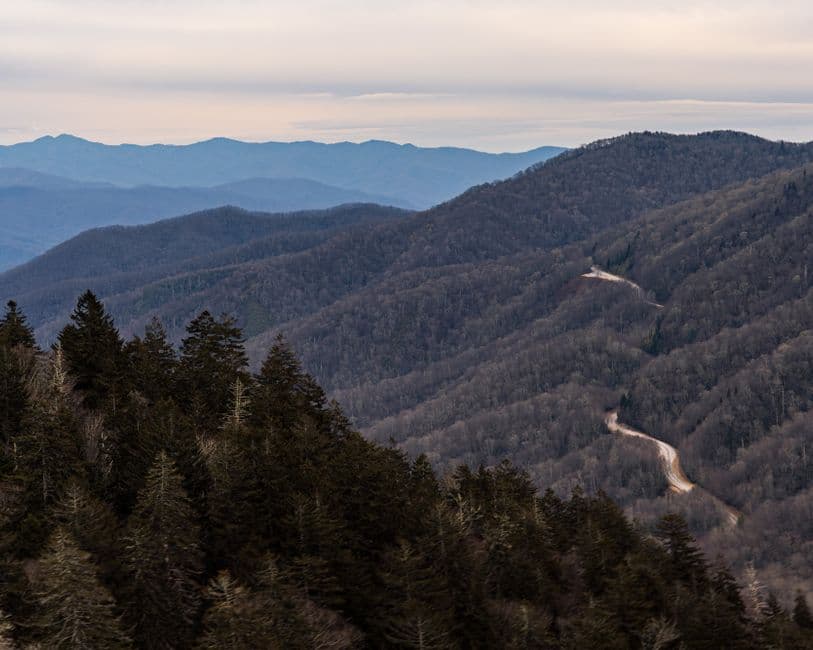 A captivating view of the Smoky Mountains with winding road, showcasing the serene winter landscape.