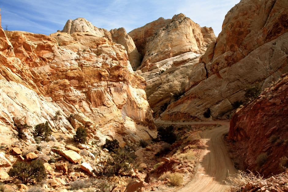 Dramatic sandstone rock formations along a dirt road on Burr Trail, Utah.